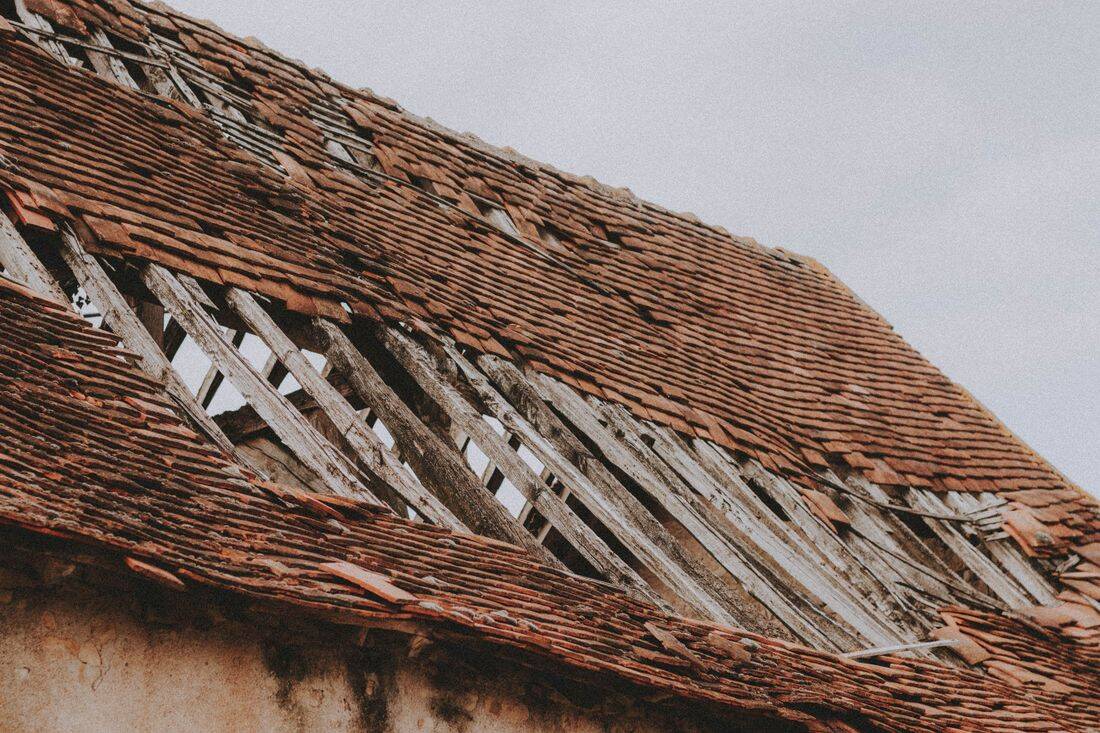 Storm-wrecked roof stripped to the battens